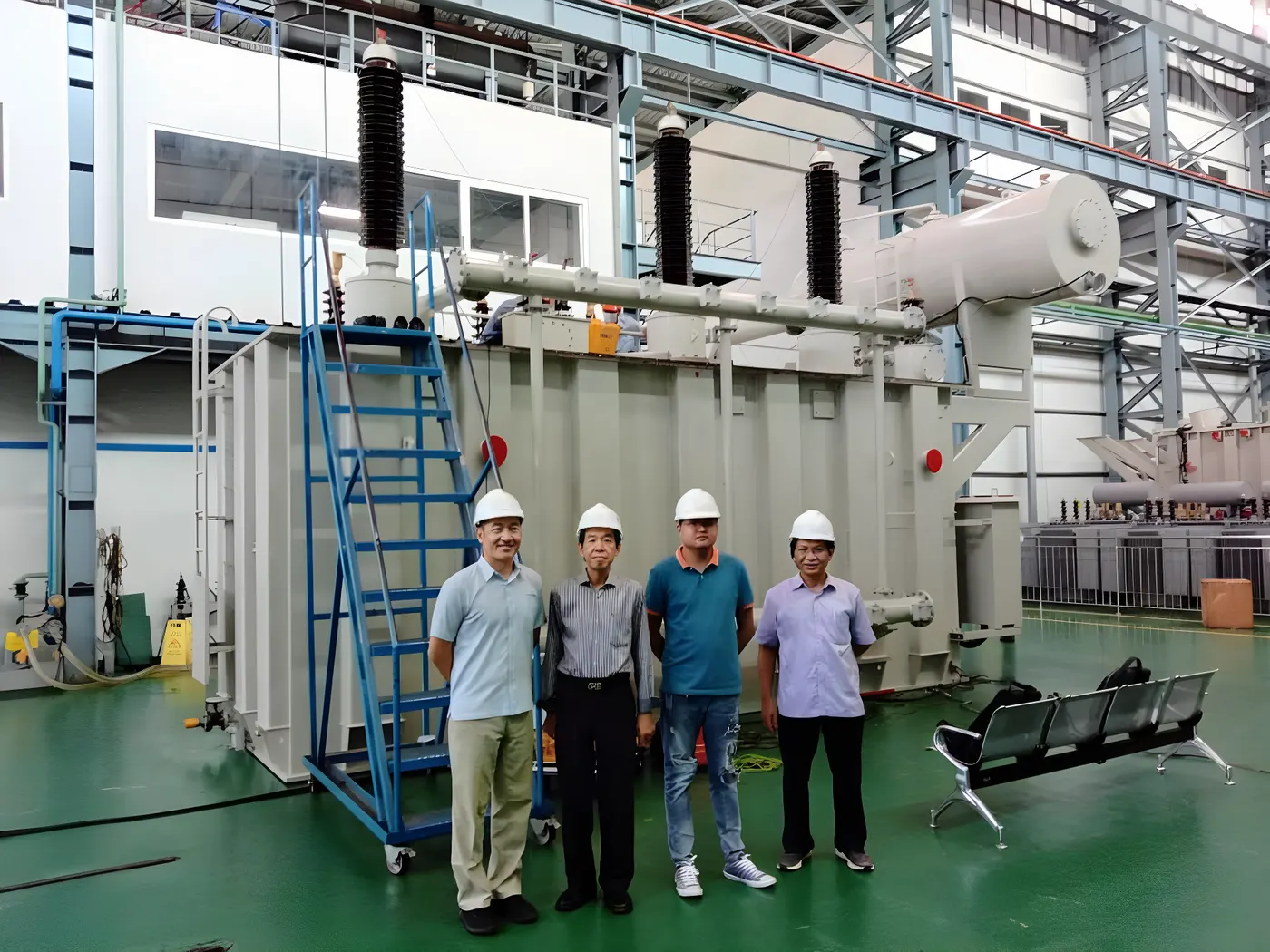 SINTRA engineers beside a 120 MVA power transformer on the test floor